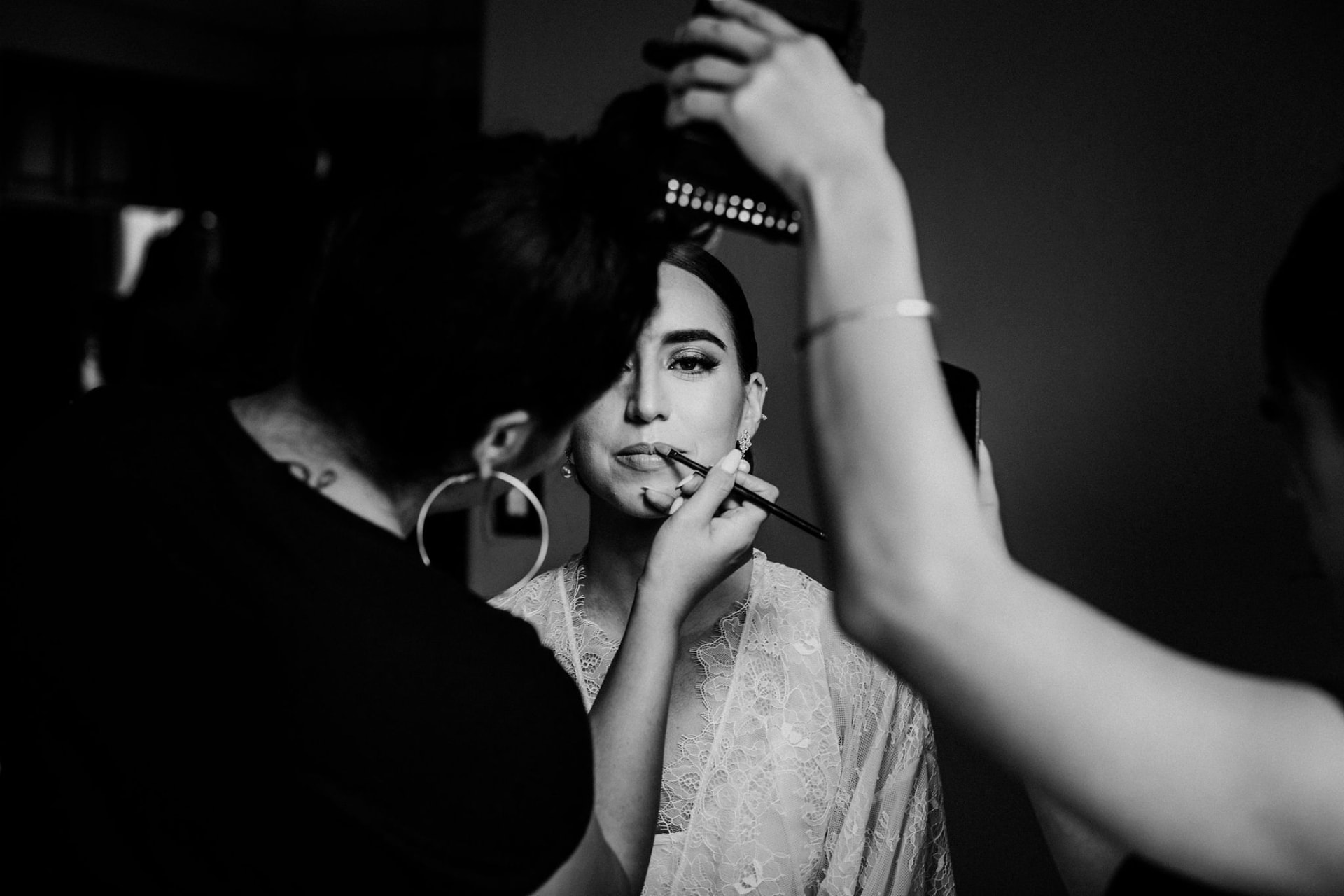Bride having makeup applied before the ceremony