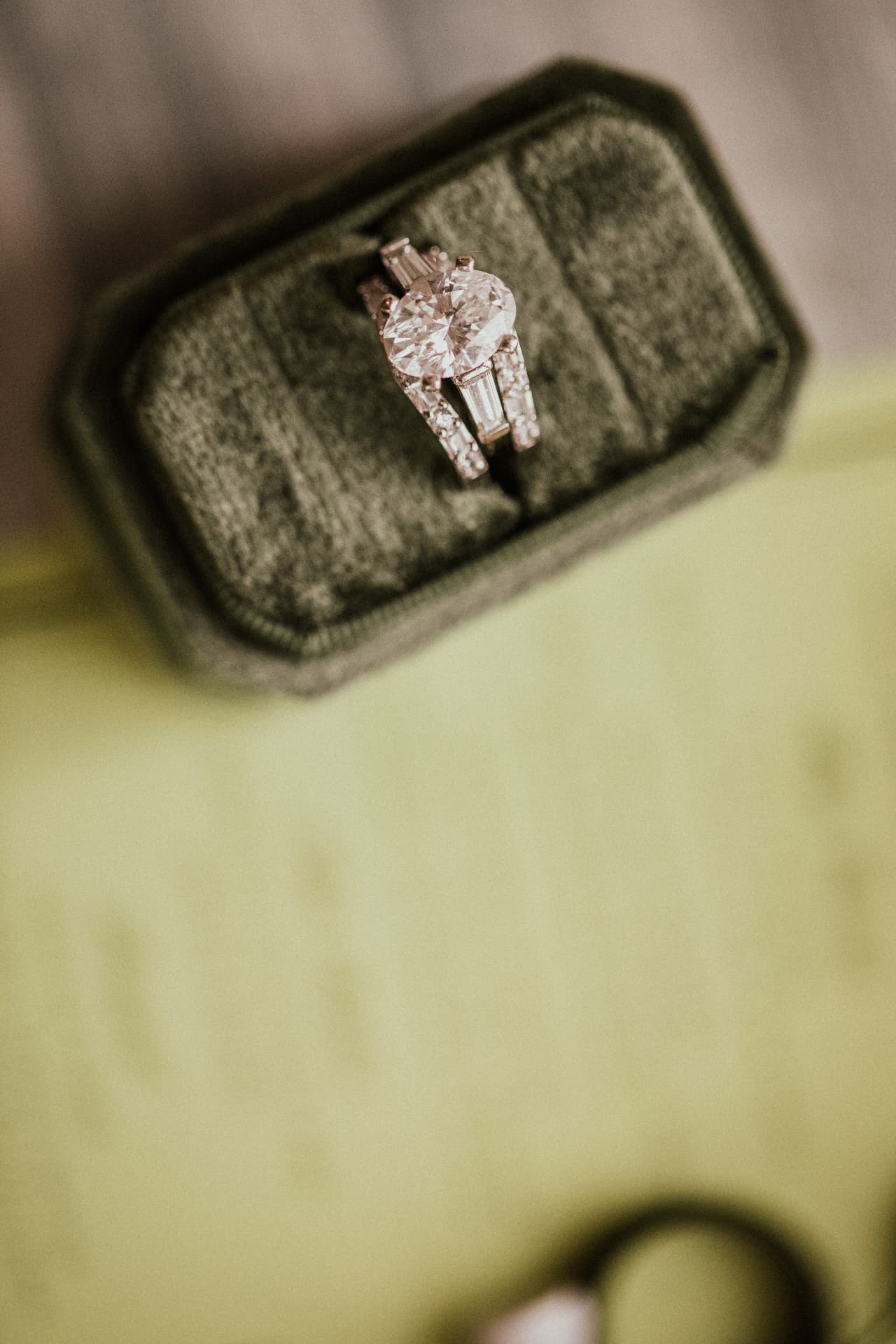 Engagement ring and band nestled in a velvet ring box