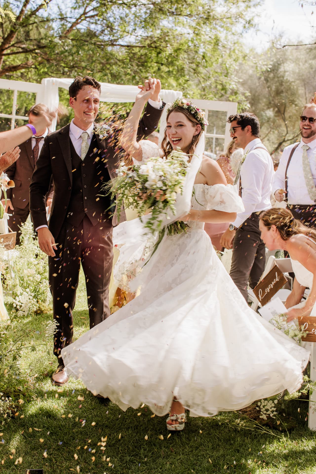 Kaley and Jacob celebrating with confetti after their wedding ceremony