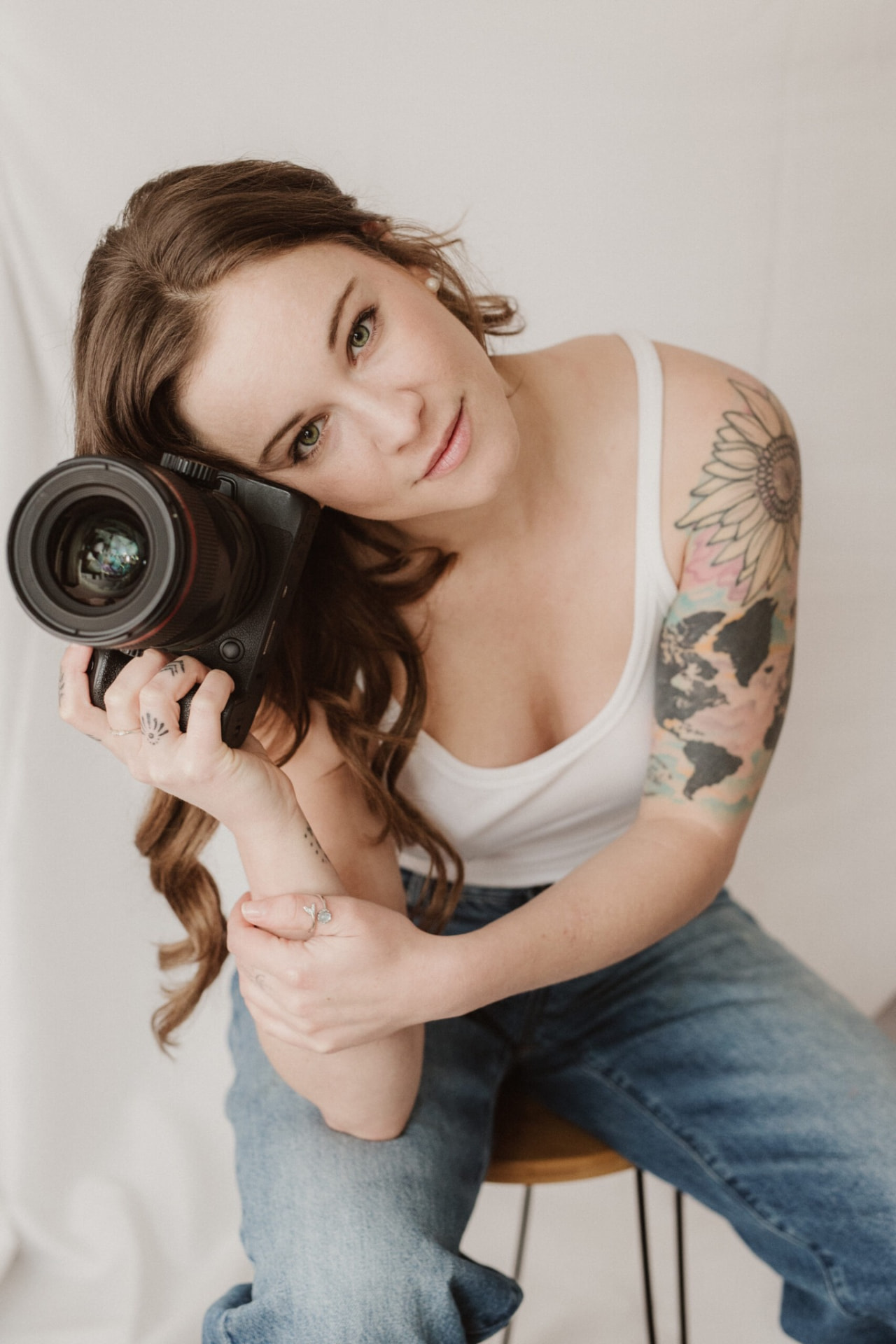 Rae, founder of Rae Photo Film, holding a camera