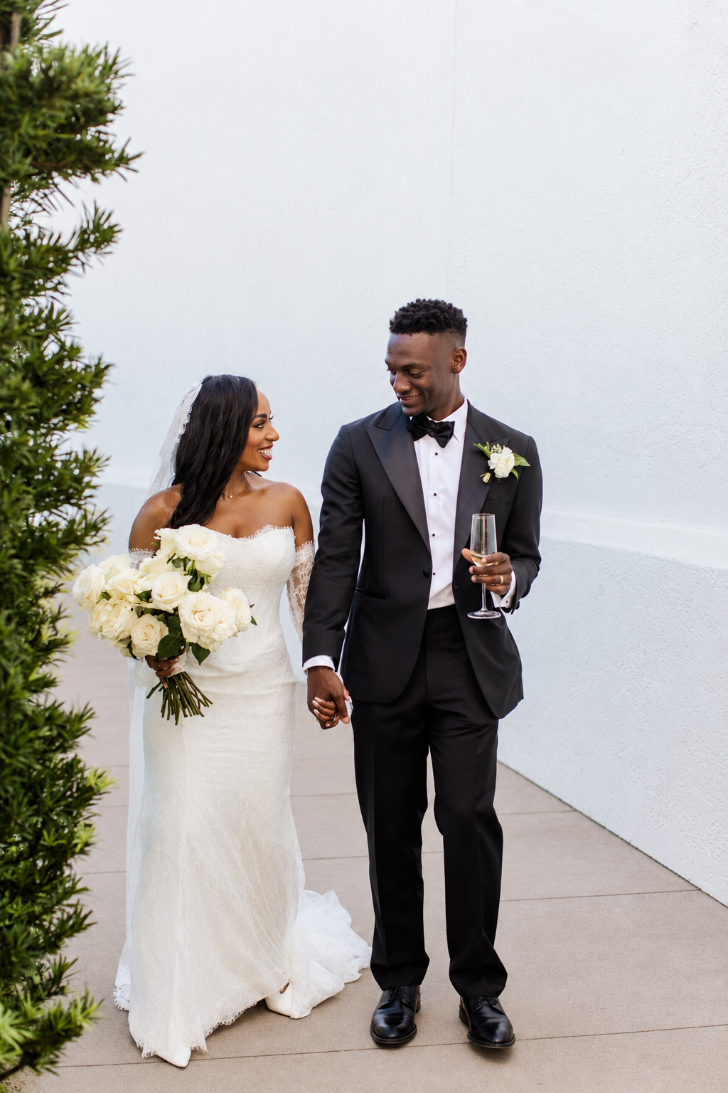 Newlyweds walking hand in hand after their San Diego wedding